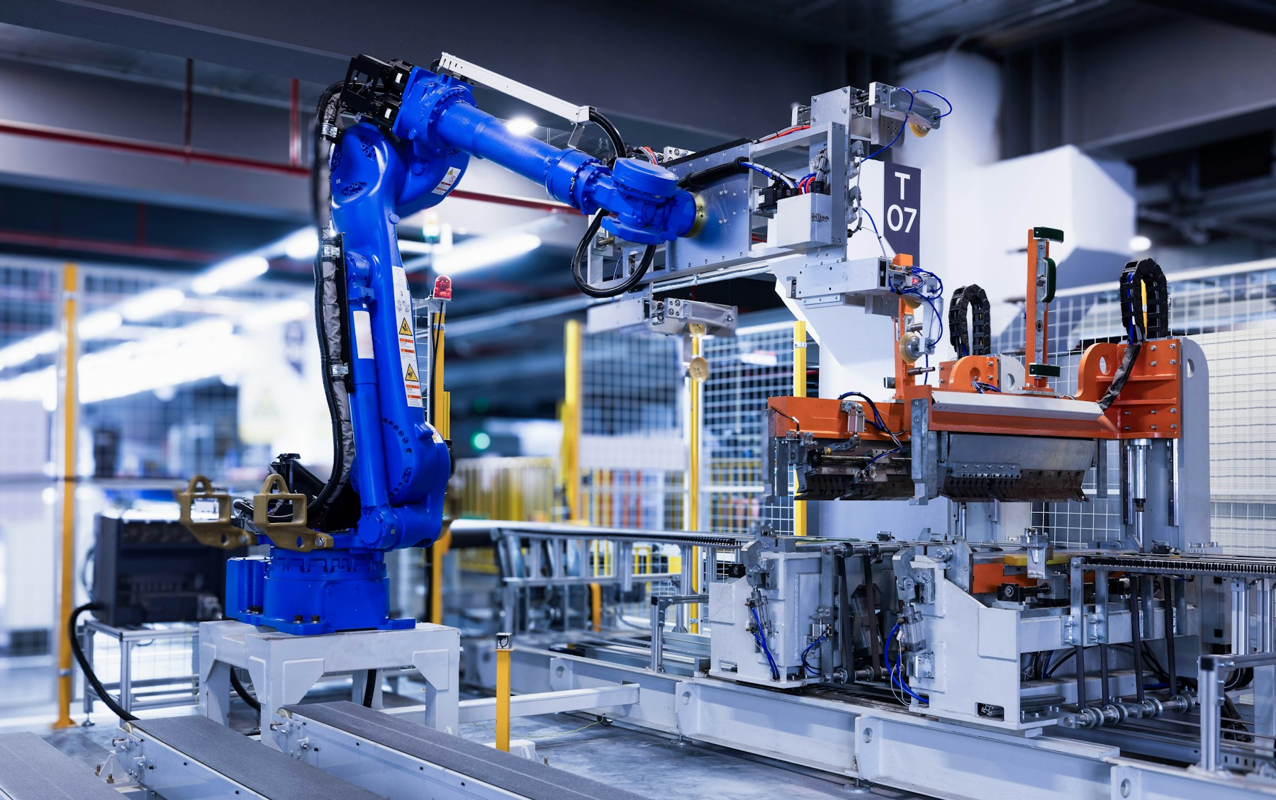 Blue industrial robot arm in a production facility